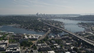 AX47_078 - 5K aerial stock footage fly away from Ship Canal Bridge and tilt to reveal Lake Union and the skyline of Downtown Seattle, Washington