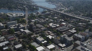 AX47_079 - 5K aerial stock footage fly over an office building, tilt to reveal the bridge, Lake Union, and Downtown Seattle skyline in Washington