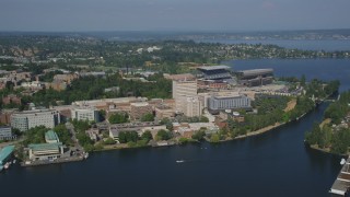 AX47_083 - 5K aerial stock footage fly over Portage Bay to approach the University of Washington campus and Husky Stadium in Seattle, Washington