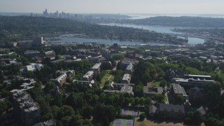 AX47_088 - 5K stock footage aerial video tilt from the University of Washington campus to reveal Portage Bay, Lake Union, and the skyline of Downtown Seattle, Washington
