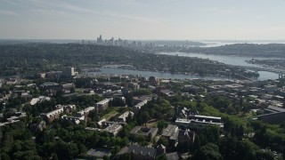 AX47_088E - 5K aerial stock footage tilt from the University of Washington campus to reveal Portage Bay, Lake Union, and the skyline of Downtown Seattle, Washington
