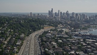 AX47_091 - 5K aerial stock footage tilt from heavy traffic on Interstate 5 to reveal and approach the Downtown Seattle skyline, Washington