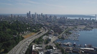 AX47_092 - 5K aerial stock footage of following heavy traffic traveling Interstate 5 to approach Downtown Seattle skyline, Washington