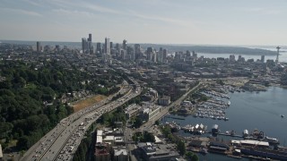 AX47_092E - 5K aerial stock footage of following heavy traffic traveling Interstate 5 to approach Downtown Seattle skyline, Washington