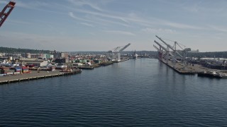 AX47_099E - 5K aerial stock footage flyby cargo cranes lining the waterway at Harbor Island, Seattle, Washington