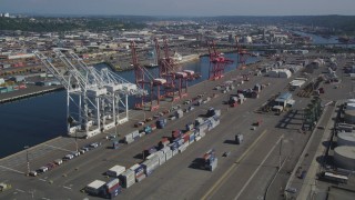 AX47_101 - 5K aerial stock footage of cargo cranes and rows of shipping containers at Harbor Island, Seattle, Washington