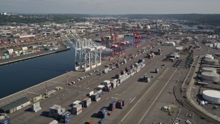 AX47_101E - 5K aerial stock footage of cargo cranes and rows of shipping containers at Harbor Island, Seattle, Washington