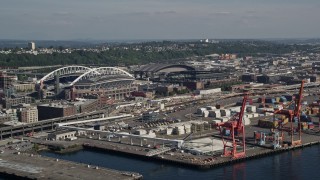AX47_121 - 5K aerial stock footage of cargo cranes near CenturyLink Field and Safeco Field in Downtown Seattle, Washington