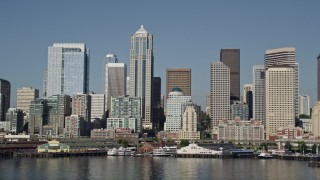 AX47_123E - 5K aerial stock footage of the Downtown Seattle skyline and Central Waterfront seen from Elliott Bay, Washington