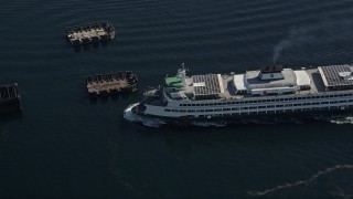AX47_137E - 5K aerial stock footage of ferry approaching the Seattle Ferry Terminal in Downtown Seattle, Washington