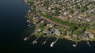 AX48_002 - 5K aerial stock footage of approach lakeside homes and tilt to docks on Lake Washington in Kennydale, Renton, Washington