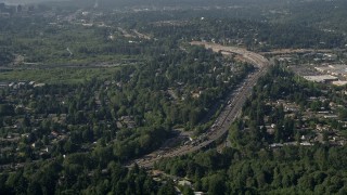 AX48_008 - 5K aerial stock footage of I-405 with traffic congestion beside a residential neighborhood, Bellevue, Washington