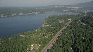 AX48_014E - 5K aerial stock footage fly over light traffic on I-90 to approach lakeside homes on the shore of Lake Sammamish in Issaquah, Washington