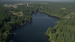 AX48_020E - 5K aerial stock footage fly over Pine Lake and tilt to lakefront homes with docks, Sammamish, Washington