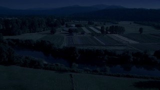 AX48_037_DFN - Aerial stock footage of 4K day for night color corrected aerial footage of the Snoqualmie River and farm fields in Carnation, Washington