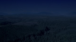 AX48_046_DFN - 4K day for night color corrected aerial stock footage of a vast evergreen forest, and approach a clear cut area in King County, Washington