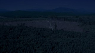AX48_048_DFN - 4K day for night color corrected aerial stock footage of a logging clear cut area in an evergreen forest, King County, Washington