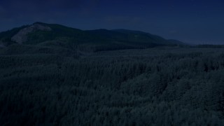 AX48_058_DFN - 4K day for night color corrected aerial stock footage of evergreen forest, reveal the South Fork Tolt Reservoir, Cascade Range, Washington