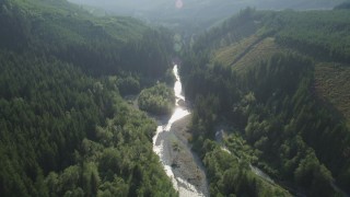 AX48_068 - 5K aerial stock footage of following a river through the forest, King County, Washington