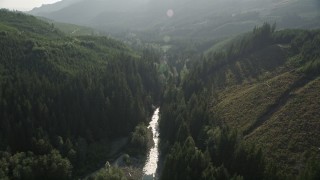 AX48_068E - 5K aerial stock footage of following a river through the forest, King County, Washington