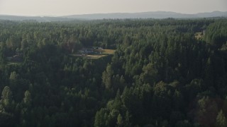 AX49_013 - 5K aerial stock footage of flying by large, upscale homes surrounded by forest, Carnation, Washington