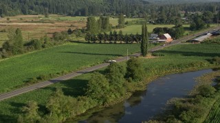 AX49_018 - 5K aerial stock footage of tracking a white van on a country road through farmland, Carnation, Washington