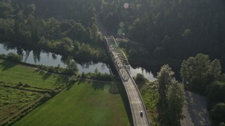 AX49_020 - 5K aerial stock footage of tracking a truck crossing a bridge spanning the Snoqualmie River, Carnation, Washington