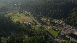 AX49_026 - 5K aerial stock footage of small farms and greenhouses by Redmond Fall City Road in Redmond, Washington
