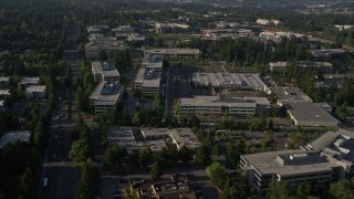 AX49_045E - 5K aerial stock footage of passing by Microsoft Headquarters office complex beside freeway with light traffic in Redmond, Washington