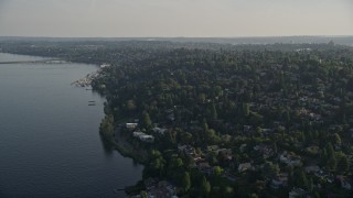 AX49_055 - 5K aerial stock footage of lakefront homes and suburban neighborhoods by Lake Washington, Madrona, Washington
