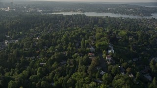 AX49_056 - 5K aerial stock footage fly by residential neighborhoods and lush green trees, Madrona, Washington