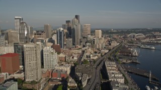 AX49_064E - 5K aerial stock footage flyby skyscrapers to reveal the Viaduct, and the Seattle Great Wheel at the Central Waterfront, Downtown Seattle, Washington