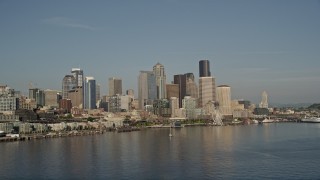 AX49_069 - 5K aerial stock footage of the Central Waterfront and downtown skyline seen from Elliott Bay, Downtown Seattle, Washington