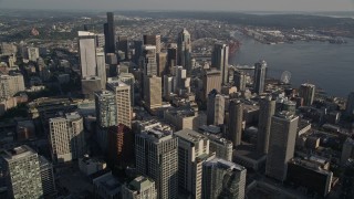 AX49_073E - 5K aerial stock footage flyby tall Downtown Seattle skyscrapers and track Two Union Square with an American flag in Washington