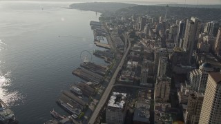 AX49_076 - Aerial stock footage of Orbit the Seattle Great Wheel, with a view of the Alaskan Way Viaduct and the Seattle Aquarium, Central Waterfront, Downtown Seattle, Washington