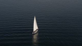 AX49_077 - 5K aerial stock footage of tracking a sailboat on the bay on Elliott Bay, Seattle, Washington
