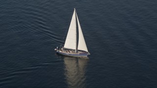 AX49_078E - 5K aerial stock footage track a sailboat sailing on Elliott Bay, Seattle, Washington
