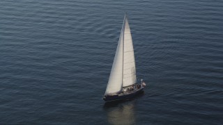 AX49_079 - 5K aerial stock footage of a sailboat sailing on Elliott Bay, Seattle, Washington