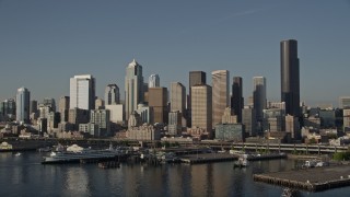 AX49_082E - 5K aerial stock footage low flyby of Central Waterfront piers, ferry terminal, and Downtown Seattle skyline, Washington
