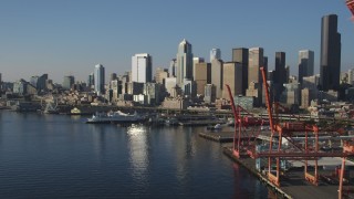 AX49_083 - 5K aerial stock footage of the Central Waterfront and Downtown Seattle skyline, reveal cargo cranes, Washington