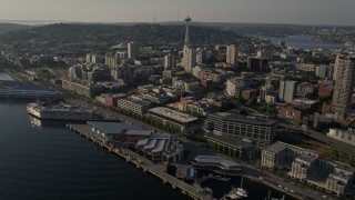 AX49_086 - 5K aerial stock footage of the iconic Seattle Space Needle seen from Central Waterfront piers, Downtown Seattle, Washington