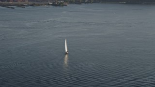 AX49_092 - 5K aerial stock footage of tracking a sailboat on Elliott Bay, Seattle, Washington