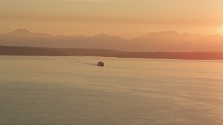 AX50_012 - 5K aerial stock footage of ferry crossing Elliott Bay at sunset, Washington