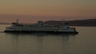 AX50_015 - 5K aerial stock footage track a ferry sailing Elliott Bay, Washington, sunset