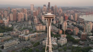 AX50_021 - 5K stock footage aerial video orbit the Space Needle and Seattle Center to reveal Downtown Seattle skyscrapers, Washington, sunset