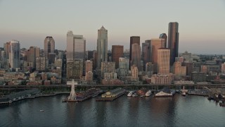AX50_023 - 5K stock footage aerial video orbit Downtown Seattle skyscrapers, Alaskan Way Viaduct, and Central Waterfront piers in Washington, sunset