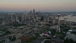 AX50_033 - 5K aerial stock footage of orbiting around the Seattle Space Needle to reveal skyscrapers in Downtown Seattle, Washington, sunset