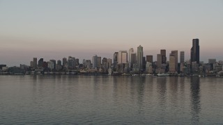 AX50_045 - 5K aerial stock footage of view of the Downtown Seattle skyline from Elliott Bay, revealing a ferry sailing the bay, Washington, sunset