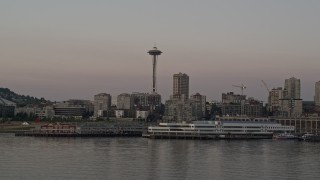 AX50_048 - 5K aerial stock footage of the Seattle Space Needle and Waterfront piers in Downtown Seattle, Washington, sunset