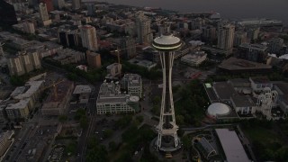 AX50_054E - 5K aerial stock footage orbit the Space Needle, tilt to reveal Downtown Seattle skyscrapers, Washington, sunset